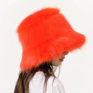 Detail showing the fluffy orange faux fur texture on the stylish winter bucket hat