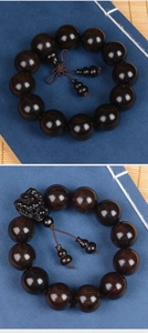 Macro detail of dark sandalwood beads with hand-carved Pixiu and polished wood texture