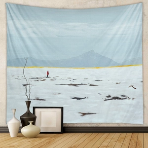 Detail of bohemian tapestry featuring minimalist landscape art on a light wall