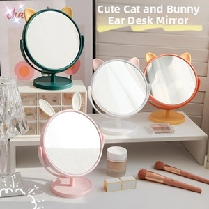 Macro detail of tulip flower plastic desktop makeup mirror with cat ear decor and round base