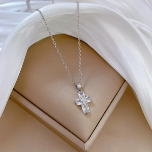 Silver cross necklace for women with clear zircon pendant in a beige jewelry box