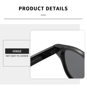 Detail of reinforced metal hinge on black round sunglasses with glossy finish
