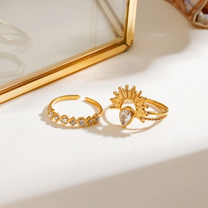 Detail of gold stacked rings with sunflower zircon and geometric pavé band design
