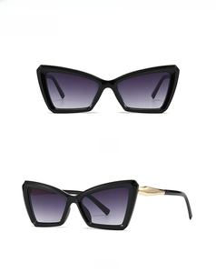 Front and side view of cat eye sunglasses with black frame and gold geometric temple detail