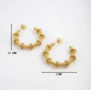 Detail view of 18K gold twist spring earrings showing dimensions 33.5MM by 31MM