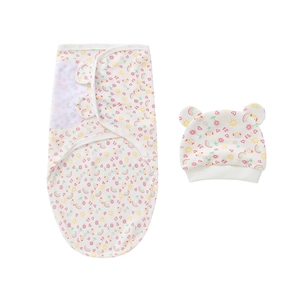 Detailed flat lay of newborn swaddle cocoon and hat set with colorful rainbow patterns
