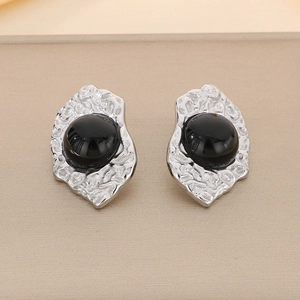 Close-up of vintage 18K gold plated geometric earrings with black cat eye stone details