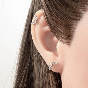 Star snowflake zircon ear cuff and stud set in silver-tone metal on model ear