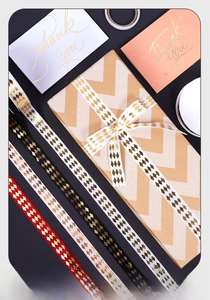 Detail of gold foil diamond pattern ribbons on gift boxes for bouquet and cake decoration