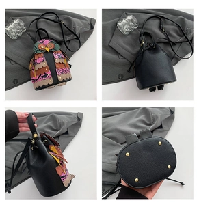 Detail views of owl bucket bag with colorful leather patchwork and drawstring closure