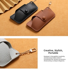Detailed view of handmade lychee pattern leather sunglass cases with gold metal chain clips