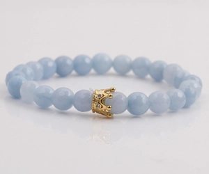 8mm light blue faceted stone bead bracelet with a detailed gold crown charm for men