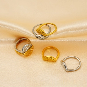 Macro detail of luxury hammered texture on two-tone gold and silver stainless steel rings