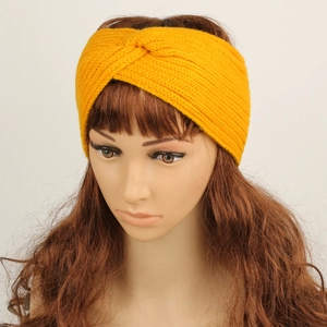 Detail of ginger yellow knitted headband with cross-knot design and thermal fleece lining