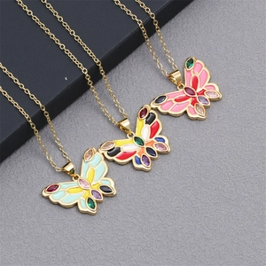 Three gold butterfly necklaces with colorful enamel and inset gems on O-chains