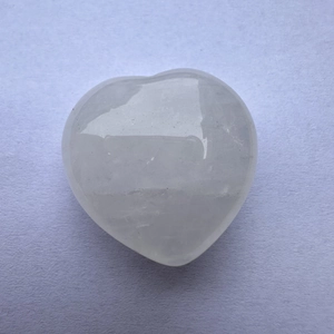 Polished heart-shaped white crystal stone ornament with natural translucent texture