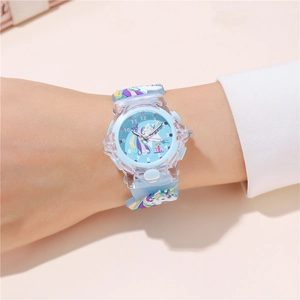 Close-up of children's unicorn watch featuring a 3D blue silicone strap and clear dial