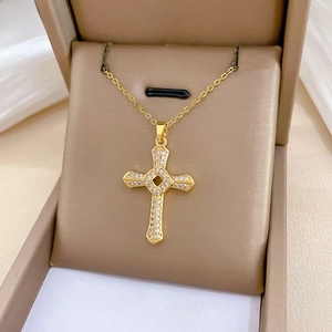 Macro detail of gold-plated spinning cross pendant with sparkling pavé cubic zirconia