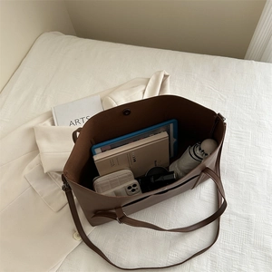 Brown large capacity vintage tote bag in PU leather showing spacious interior with essentials