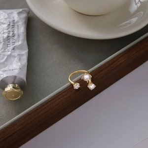 Elegant gold titanium steel open ring with three sparkling cubic zirconia stones
