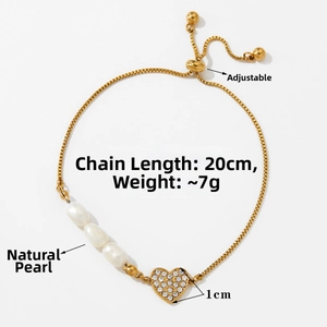 Detail of adjustable golden heart pearl bracelet with sparkling cubic zirconia charms