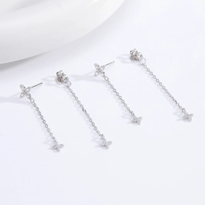 Detailed macro view of S925 sterling silver flower stud earrings with long chain tassels