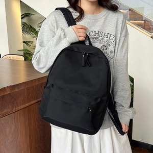 Minimalist black lightweight nylon backpack with large capacity for casual daily travel use