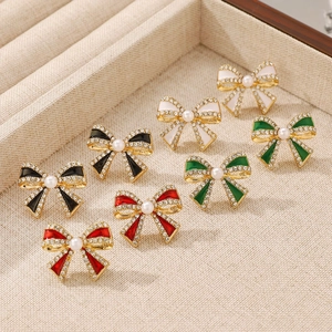 Detail of colorful bow earrings with shimmering rhinestones and faux pearl centers