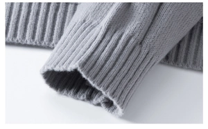 Macro shot of light gray rib-knit cuffs showing high-quality knitted fabric texture