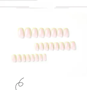 Detail of pink French press-on nails with bright yellow tips in various sizes