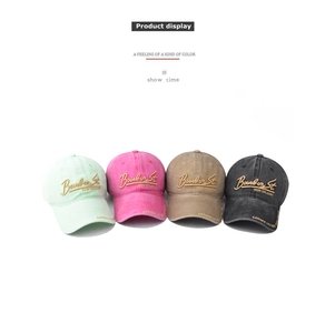 Detail of four washed cotton baseball caps with 3D embroidery in multiple colors