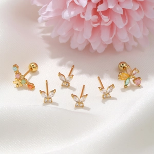 6-piece gold butterfly and flower stud set with zircon crystals on white silk