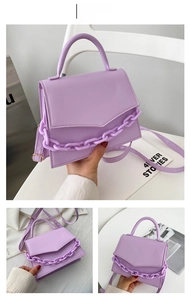 Detail view of purple PU leather crossbody bag with chunky chain and gold hardware