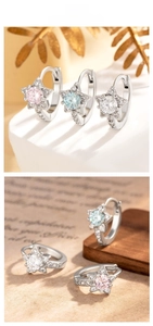 Detailed view of star-shaped earrings with colorful heart and arrow zircon stones