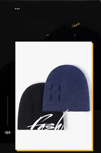 Detail of thick winter knit beanies in navy and black featuring geometric jacquard patterns