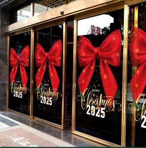 Detail of red Christmas bow window sticker with Merry Christmas 2025 text on glass