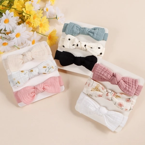 Set of 9 elastic cotton bow headbands for babies in assorted colors and floral patterns
