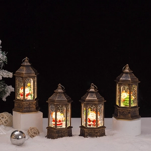 Close-up of vintage bronze Christmas lanterns with LED glowing scene on white snow