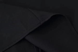 Close-up of black fabric featuring high-density weaving and professional stitching detail