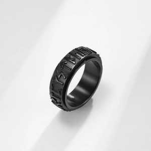 Black rotatable stainless steel Viking ring with engraved Nordic runes on matte surface
