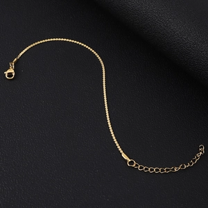 Close-up of gold stainless steel chain with lobster clasp and adjustable link