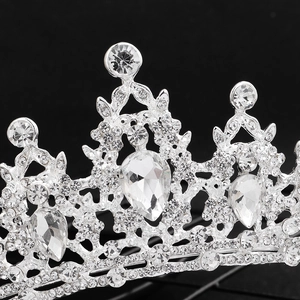 Macro shot of sparkling rhinestones and teardrop gemstones on a bridal silver crown