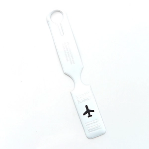 Silver metal luggage tag with engraved airplane icon and Happy Flight travel slogan