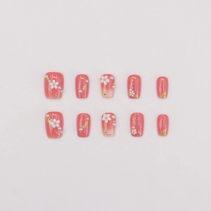 Short square press-on nails in coral pink with 3D white flowers and tiny pearls