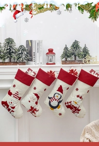 Detailed view of four festive Christmas stockings hanging on a mantle with 3D cartoon characters