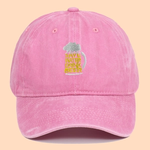 Pink washed cotton baseball cap featuring Save Water Drink Beer embroidery
