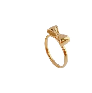 Elegant polished golden bow ring for women with a minimalist luxury style aesthetic