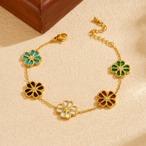 Gold-plated chain bracelet featuring colorful daisy flower charms and sparkling crystals