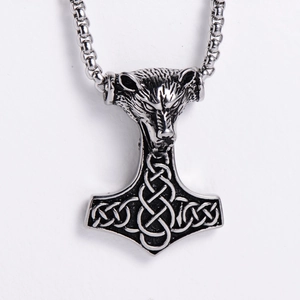 Detailed shot of silver stainless steel wolf head and Thor's Hammer Mjolnir pendant