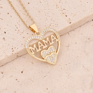 Gold heart pendant necklace with MAMA lettering and cubic zirconia on beige stone